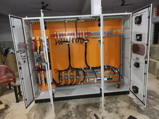 Large open panel with orange mounting plate and cabling